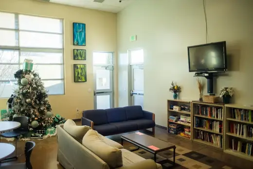 Bright common area with a Christmas tree at The Allumbaugh House detox center in Idaho.