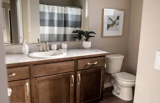 Modern bathroom with wooden cabinetry at White House Recovery detox center in Idaho.