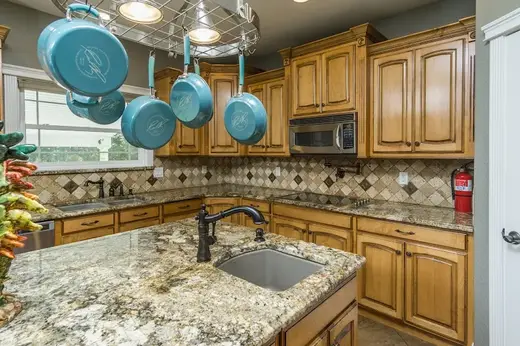 Modern kitchen with granite countertops at Moonlight Mountain Recovery & Menta, a sober living home in Idaho.